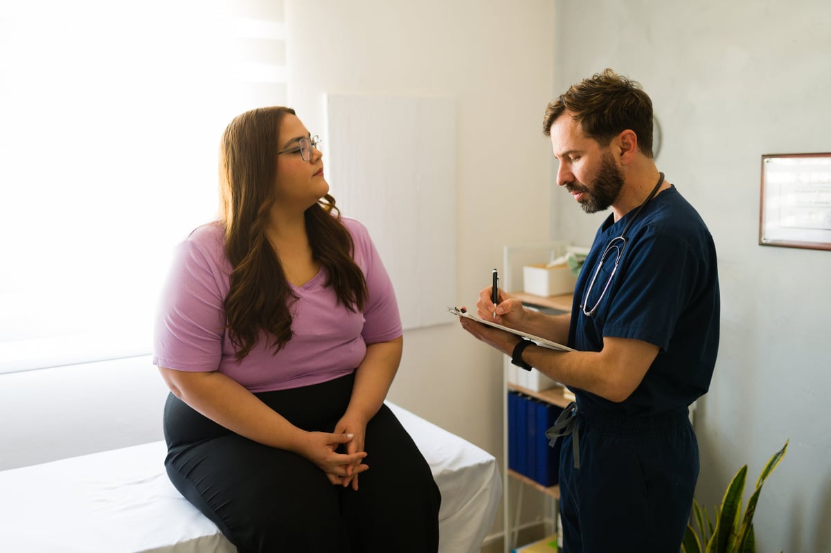 A patient speaking with a doctor during a visit to Valencia Family Medicine